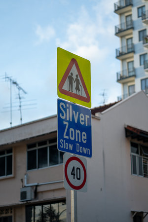 Silver zone slow down sign - traffic information sign. Vertical shotの写真素材