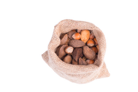 Mix of nuts and try fruits isolated on a white backdrop, raisons, almonds, nuts