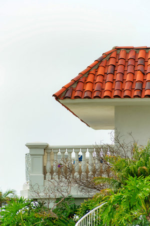A modern residential building with white-painted walls and a balconyの写真素材