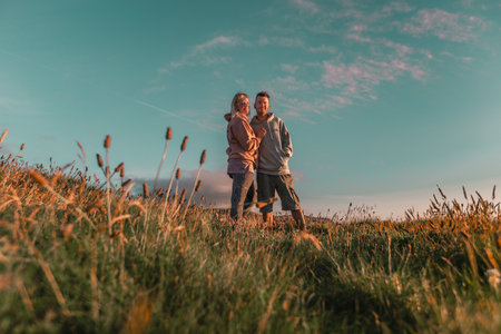 A couple enjoying the sunset in a fieldの写真素材