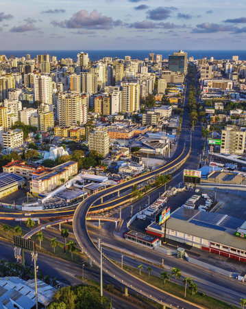 A vertical shot of roads surrounded by buildings under the sunlight in Santo Domingo, the Dominican...