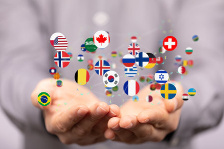 A hand holding icons of various flags - the concept of globalizationの写真素材
