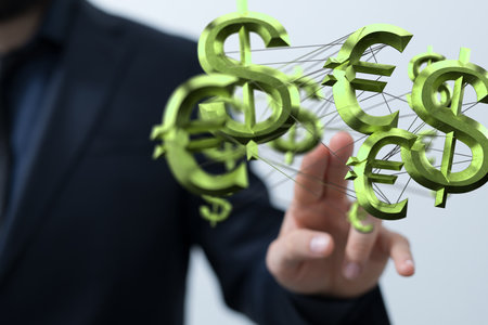 A businessman holding different virtual 3D currency symbolsの写真素材