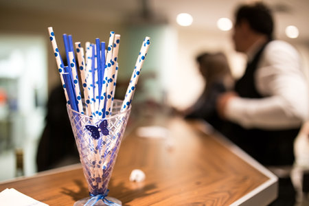 A selective focus shot of dotted plastic cocktail straws in a glass jar in the barの写真素材