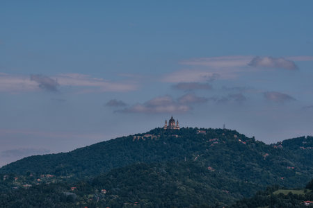 An aerial shot of Basilica of Superga church on the top of a greenery-covered hill in Italyの写真素材
