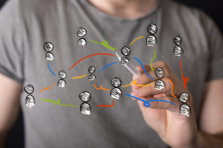 A hand coloring a floating network icon with a white pencilの写真素材