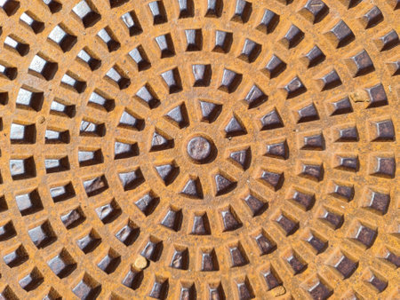 A closeup shot of a rusted metal lid of a sewer manholeの写真素材