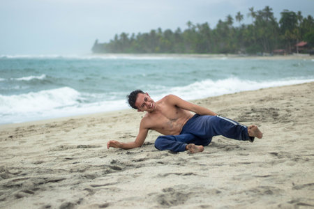 A scenic view of a Hispanic man lying on the beach on a cloudy day