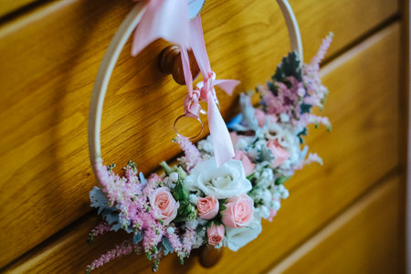 A beautiful wedding wreath hanging on a wooden drawerの写真素材