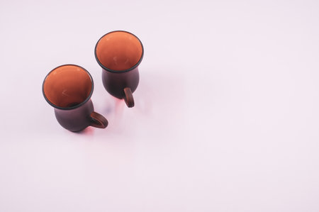 a high angle shot of two empty cups of coffee on a white surfaceの写真素材