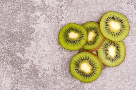 Fresh kiwi on a textured background, empty copy space for text, vegan foodの写真素材