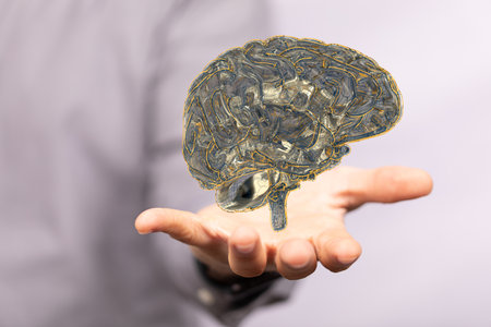 A 3D rendering of a floating human brain above a handの写真素材