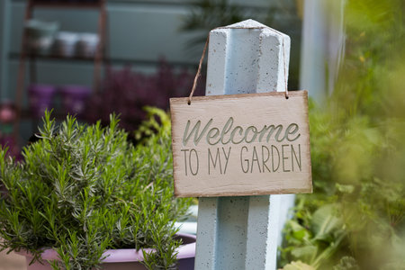 A wooden sign welcoming to the gardenの写真素材