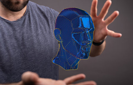 A person presenting a 3D render of a cyborg head constructionの写真素材