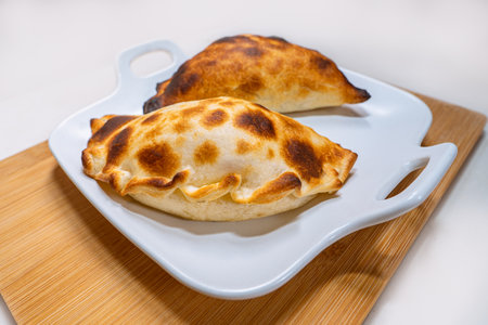 A closeup shot of calzone on a white trayの写真素材