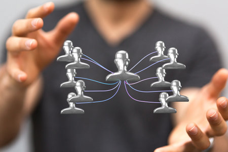 A 3D rendered people silhouettes in the network team held in person's hands
