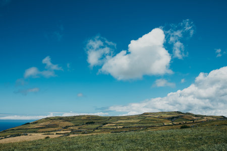 A scenic cloudscape over the vast landscapes by the seashore, Portuguese Azoresの写真素材
