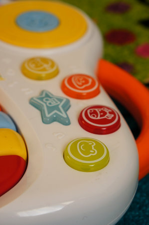 A closeup shot of a colorful toddler toy on a carpet