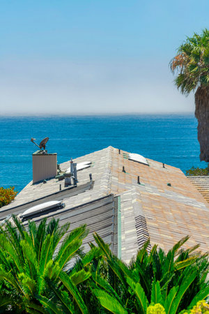 A top view of the roof of a residential building near a shore at summertimeの写真素材