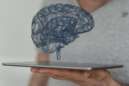 A 3D rendered blue brain hovering over a tablet - Artificial Intelligenceの写真素材