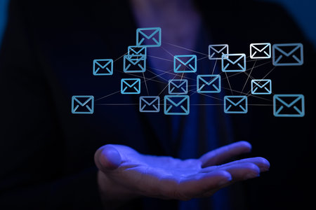 A male's hand holding an illustrated Email Inbox Electronic Communication Graphics Conceptの写真素材