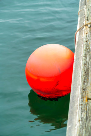 A closeup shot of a red ball on lake
