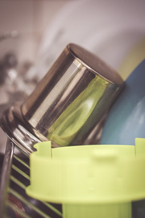 A vertical shot of a metal tea filter