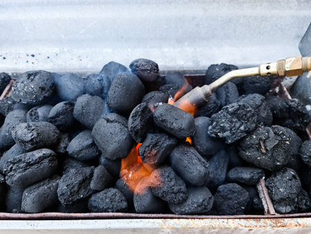 The preparing of charcoal with a gas burner for a barbecueの写真素材