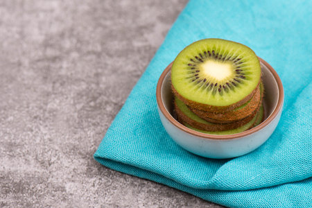 Fresh kiwi on a textured background, empty copy space for text, vegan foodの写真素材