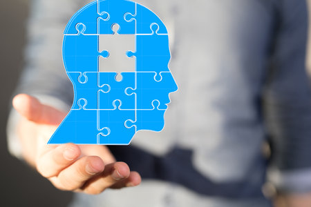 A human head in hands as a mind, brain, power, and energy conceptの写真素材