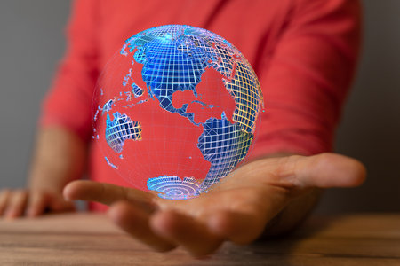 A 3D rendered futuristic globe hovering over a man's handの写真素材
