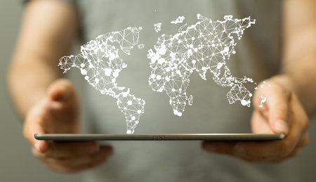 An illustration of a global network map on a tablet in handsの写真素材