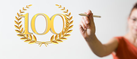 A male's hands holding a 3d rendering illustration of 100 years anniversary logotypeの写真素材