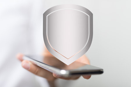 A concept of cybersecurity and information or network protection, 3d shield floating out of the mobile screenの写真素材