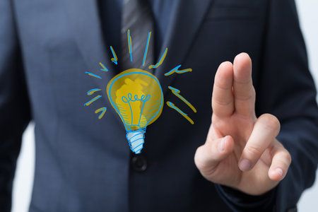 A person presenting a 3D render of idea lampの写真素材