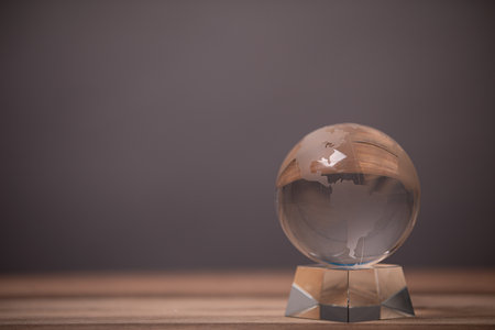 A closeup shot of a glass globe on a blurred backgroundの写真素材