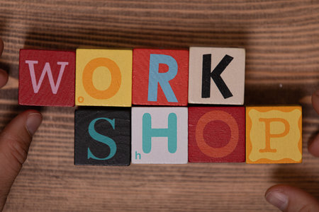 A top view of the word 'workshop' made with colorful wooden cubesの写真素材