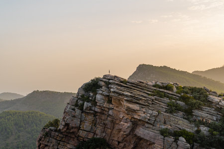 Sunset at the Garbi viewpoint with a woman standing alone located in the Sierra Calderona natural park. Valencia Spain.の写真素材