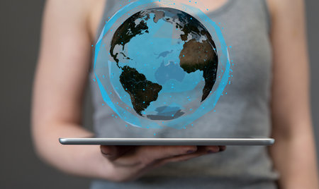 An illustration of a digital globe network on a tabletの写真素材