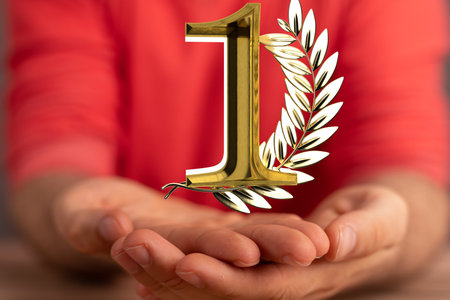A 3d golden rendering of 1 with laurel wreath hovering over man's palms - anniversary and success conceptの写真素材