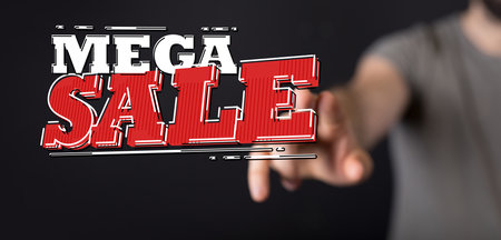 A male's hand pointing to an illustration of a huge mega saleの写真素材