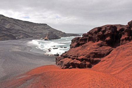 Red and black sand on Lava beach on spanish canary island Lanzarote, Spainの写真素材