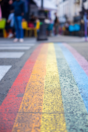 A vertical shot of a street colored with rainbow LGBTQ colors with blurred backgroundの写真素材