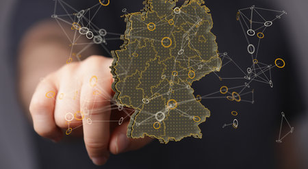 A 3D rendering of a digital hologram of Germany map with a finger tapping on it from the backgroundの写真素材