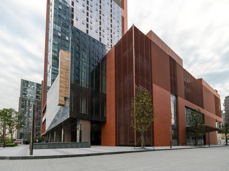 A modern building structure with an edgy design against a cloudy sky