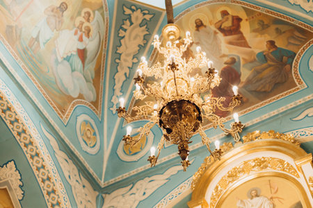 A low angle shot of an illuminatechandelier in a churchの写真素材