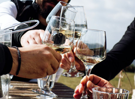 A closeup shot of people cheering to something outdoorsの写真素材