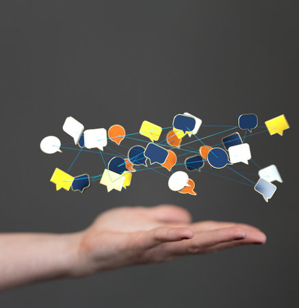 A closeup of 3D rendered digital speech bubbles teamwork connection hovering in man's handの写真素材