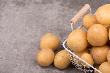 A closeup shot of fresh potatoes on a rusty surfaceの写真素材
