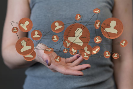 A 3D rendering of interconnected people on a woman's palm - global networking and connection conceptの写真素材